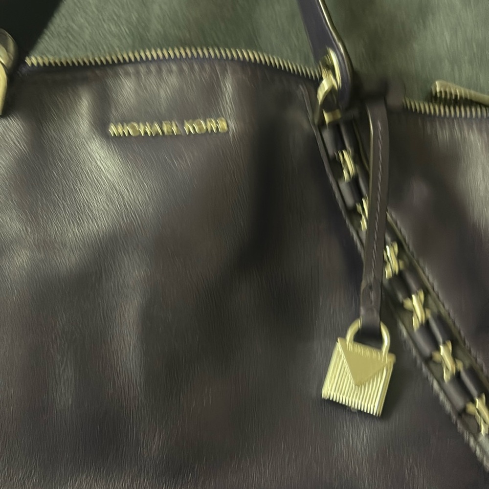 Hand bag has very little use, 2 light scratches on bottom of purse.